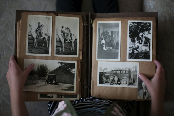 An open photo album of old black-and-white family photos