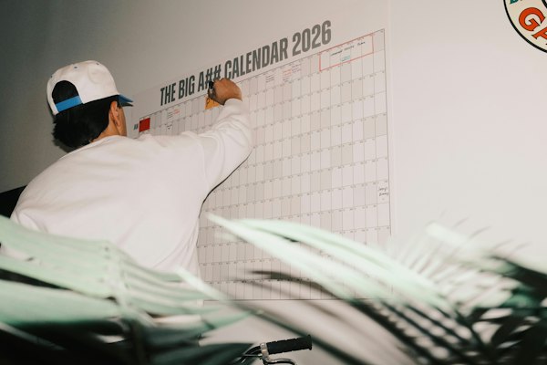 A large wall calendar being written on