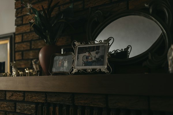 Framed family photos on a mantelpiece