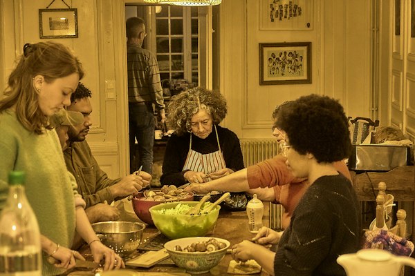 Friends cooking a meal together in a kitchen